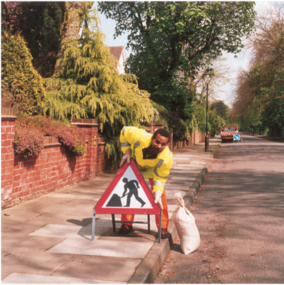 Man placing safety sign